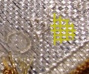 Plastic coating with fine square grid of indentations on Lion Brothers patch